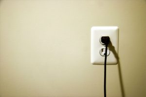 outlet-on-wall-with-cord-plugged-in