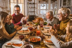 multigenerational-family-gathered-around-thanksgiving-feast