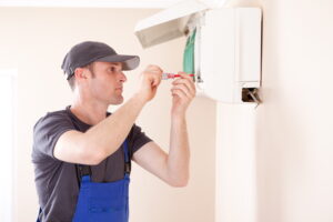 HVAC-technician-performing-maintenance-on-a-ductless-mini-split-air-handler