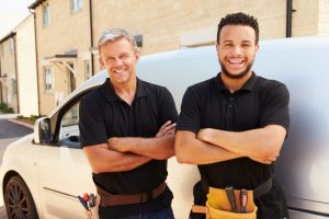 smiling-HVAC-technicians-with-work-truck