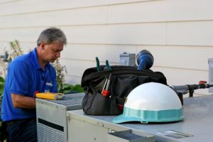 HVAC-technician-performing-AC-repairs